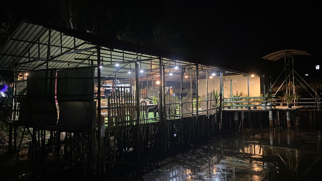 Waterfront dining area glowing at night